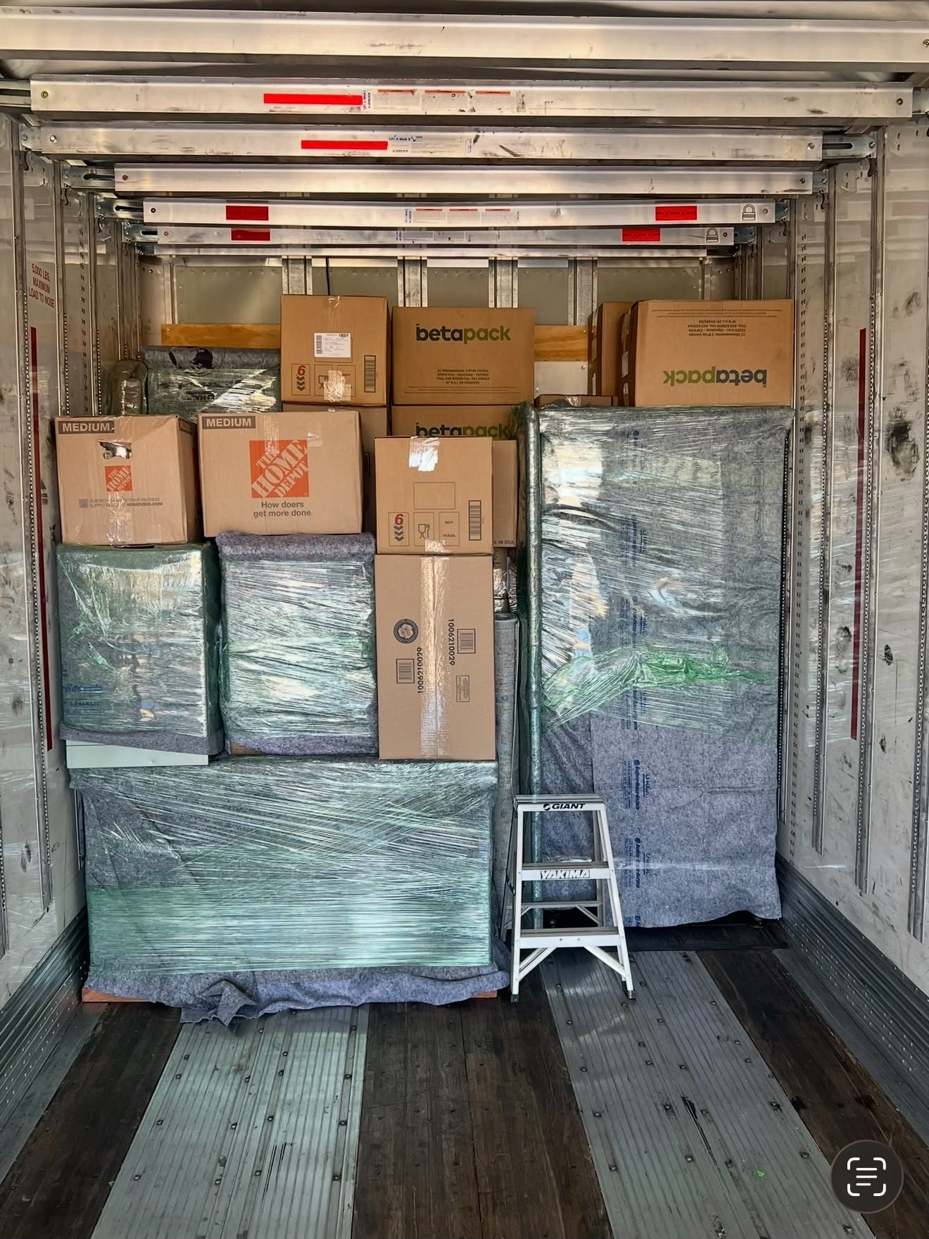 Boxes and wrapped furniture loaded inside the truck