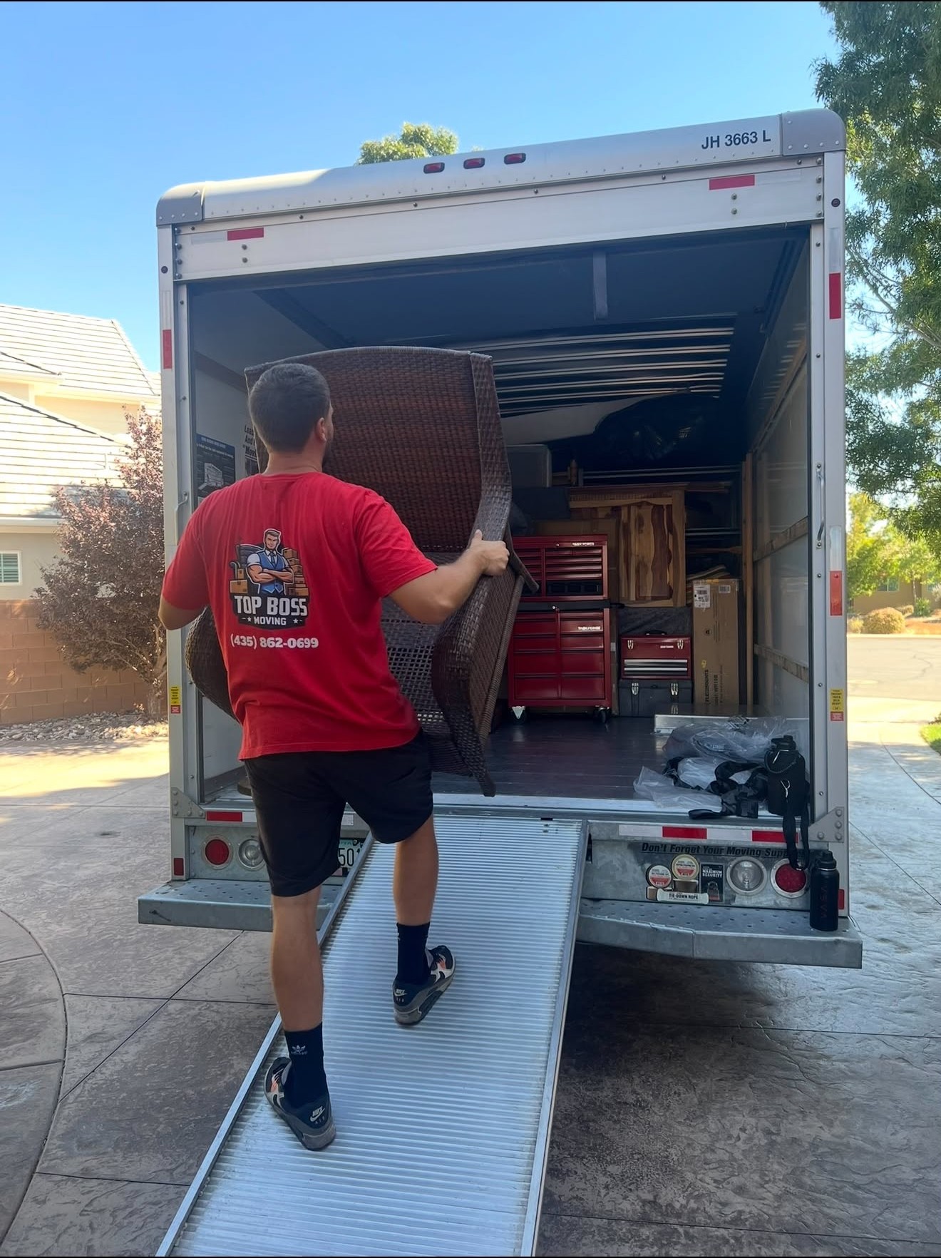 Top Boss movers carrying furniture up the truck ramp